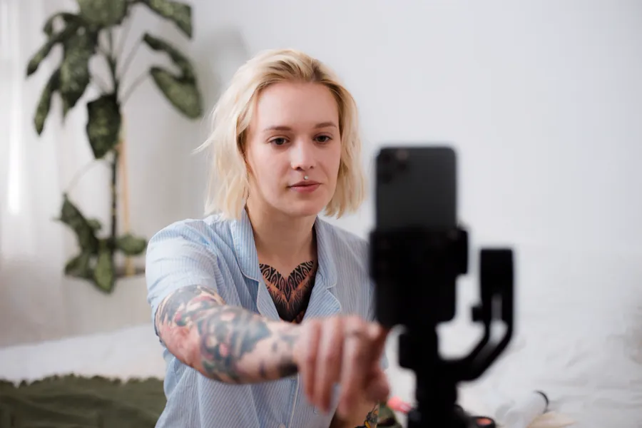 A content creator filming a short-form video on a smartphone